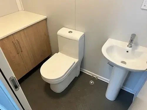 Container aménagé en bureau avec salle de bain et espace de rangement